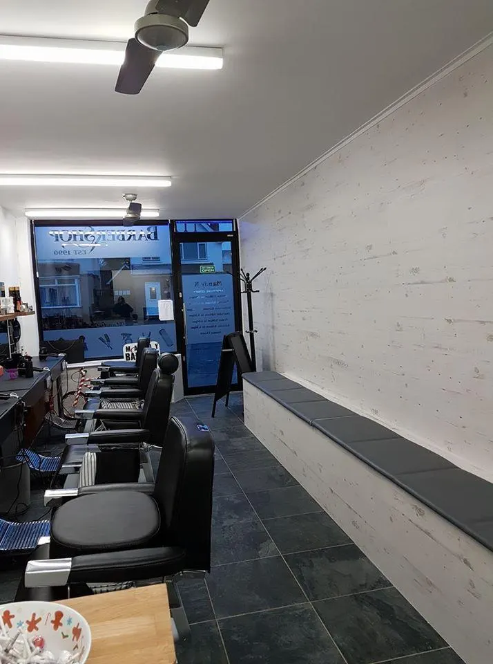 The barber chairs, looking towards the front window